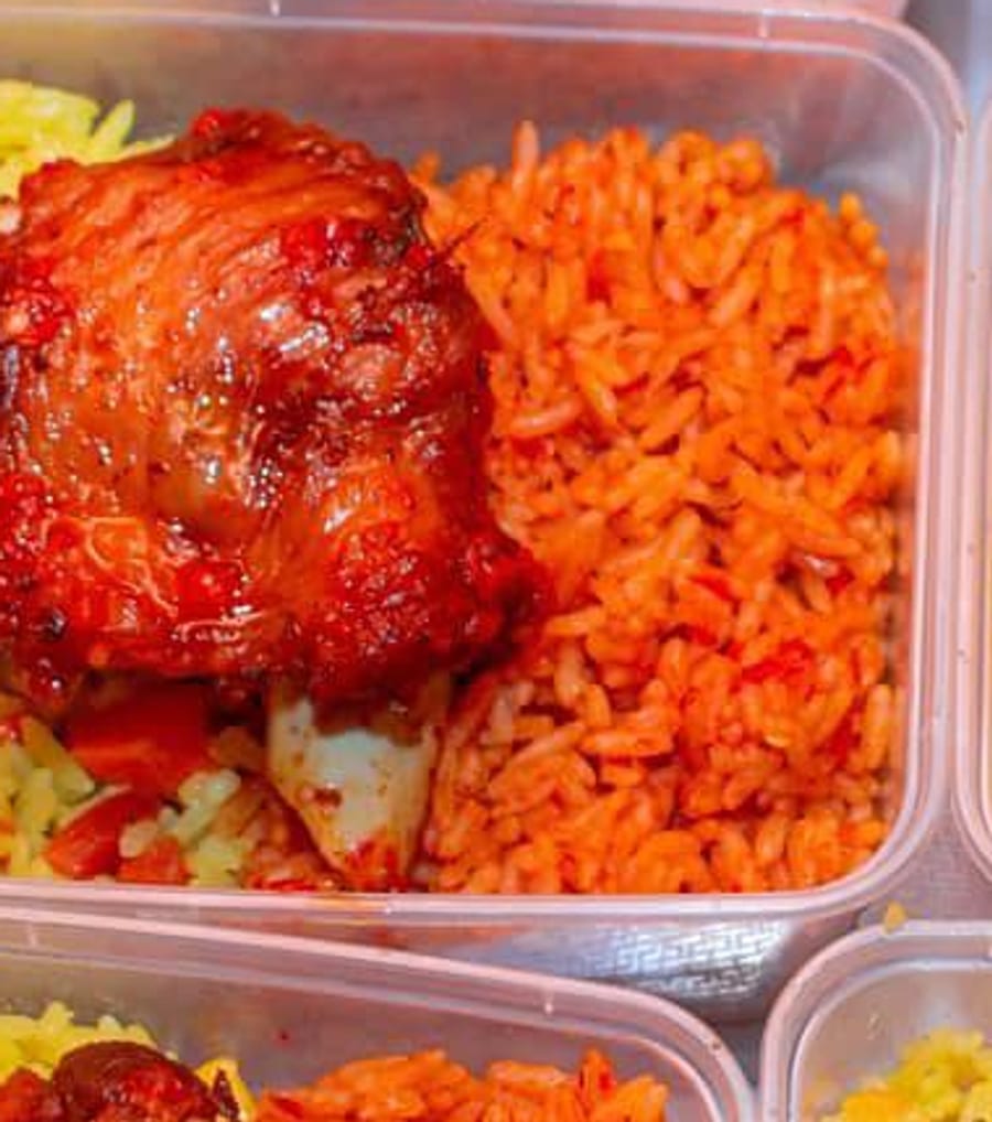 Close-up of NaijaBites smoky jollof rice with grilled chicken